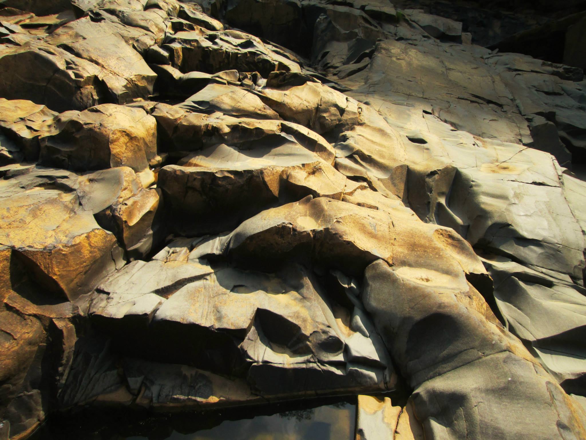 A photo of a canyon floor with rippled surface of rock.